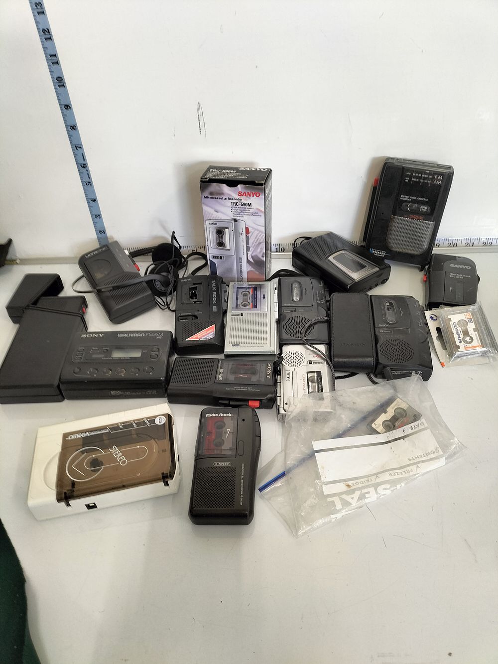 Lot 177 – A Collection of Vintage Sony, Sanyo, and Radio Shack Portable Audio Players and Recorders