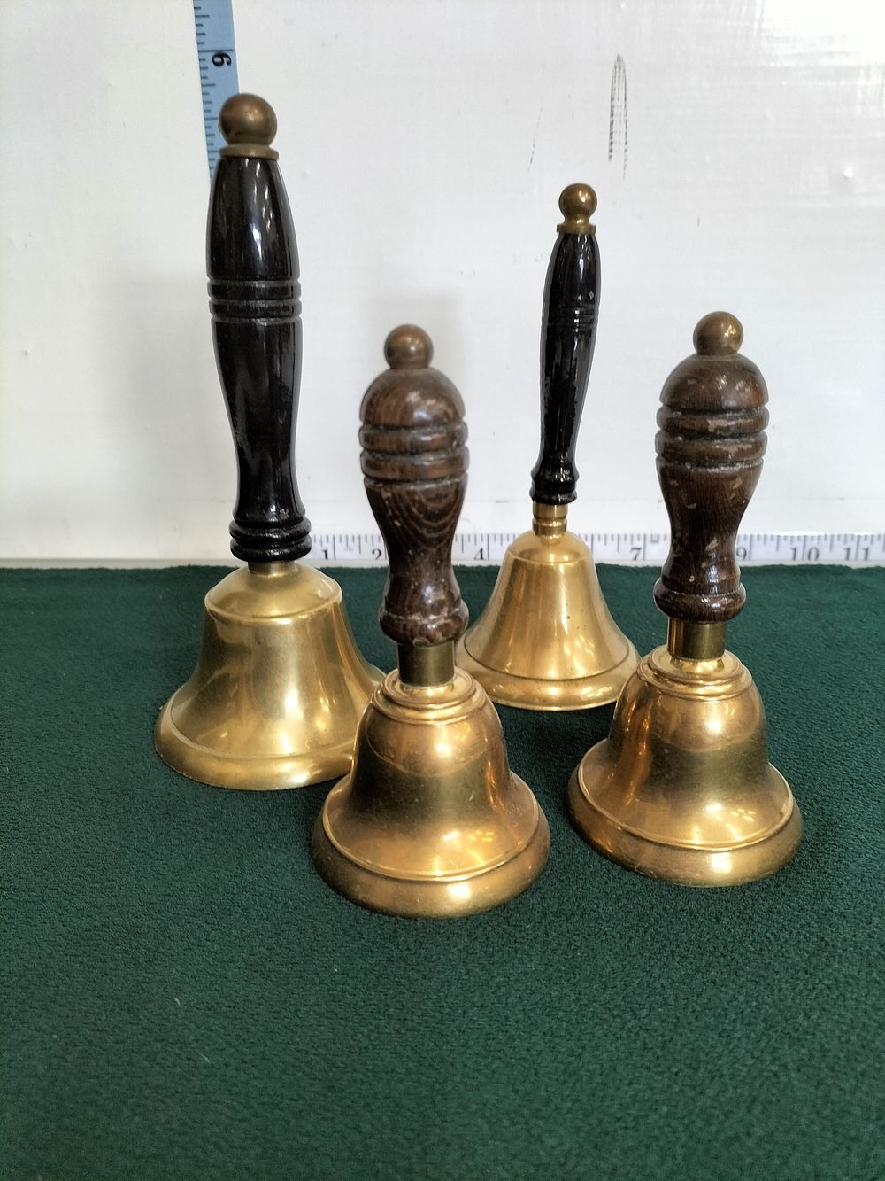 Lot 202 – A Set of Brass Hand Bells with Wooden Handles