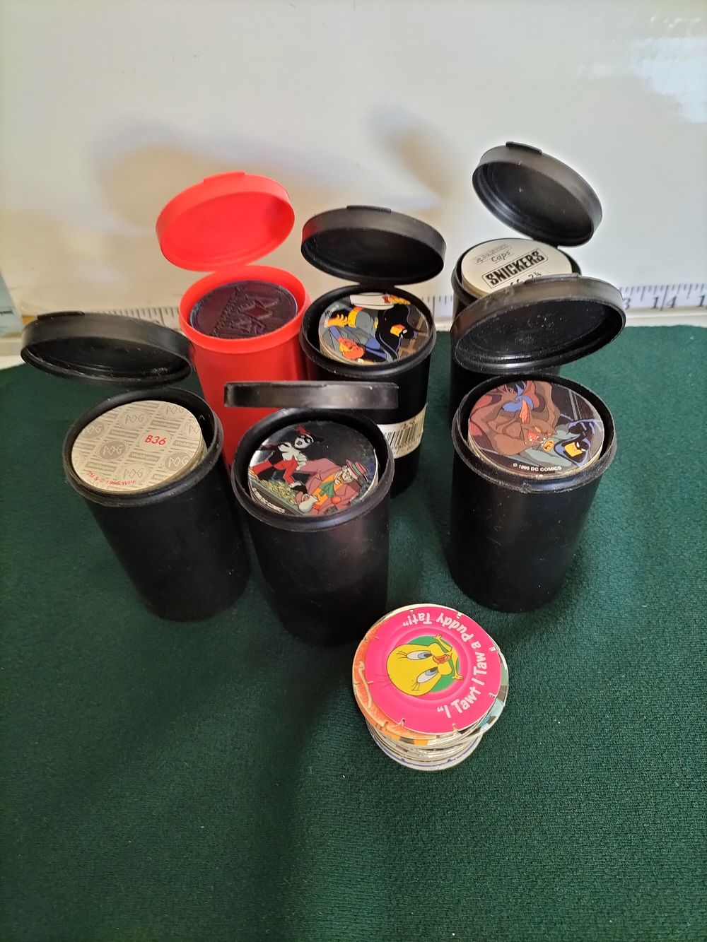 Lot 243 – A Collection of World Pog Federation Milk Caps and Six Official Storage Containers, circa 1995