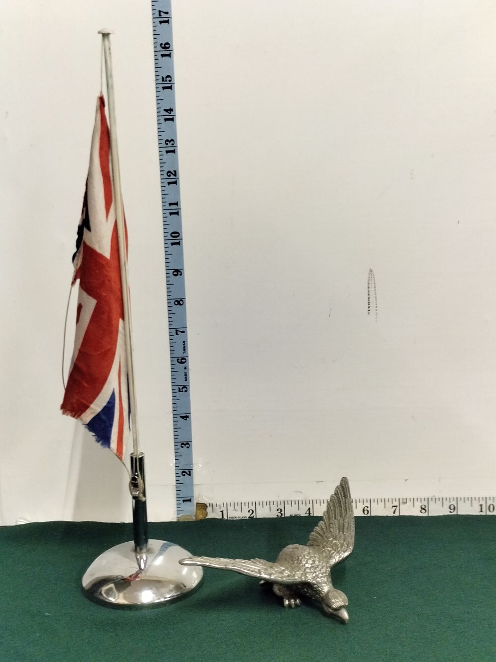 Lot 282 – Two Items Comprising a Miniature Union Jack Desk Flag and a Cast Metal Eagle Finial