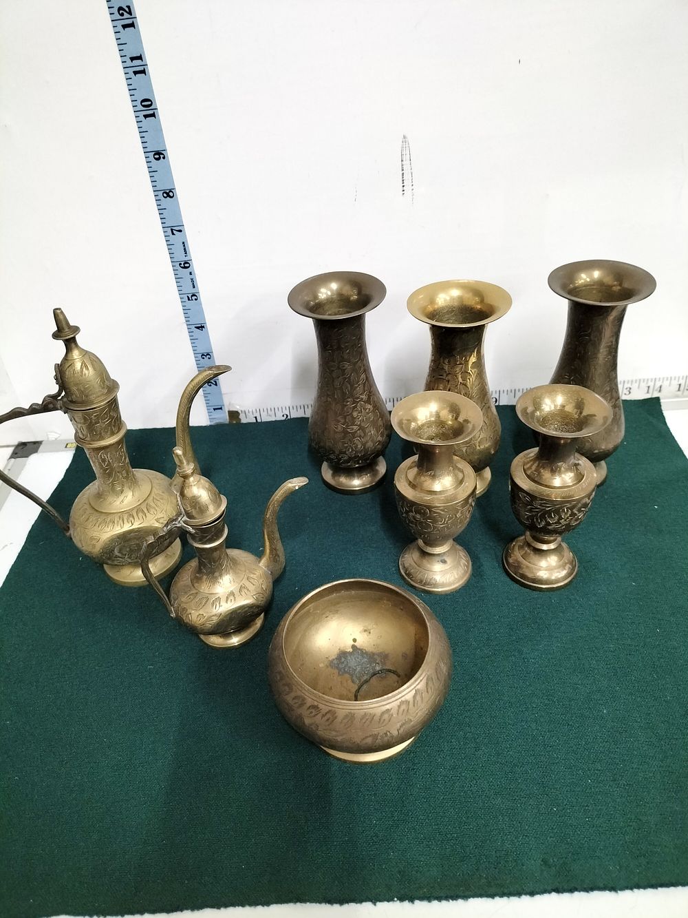 Lot 297 – A Collection of Eight Indian and Indo-Persian Style Chased Brass Vessels