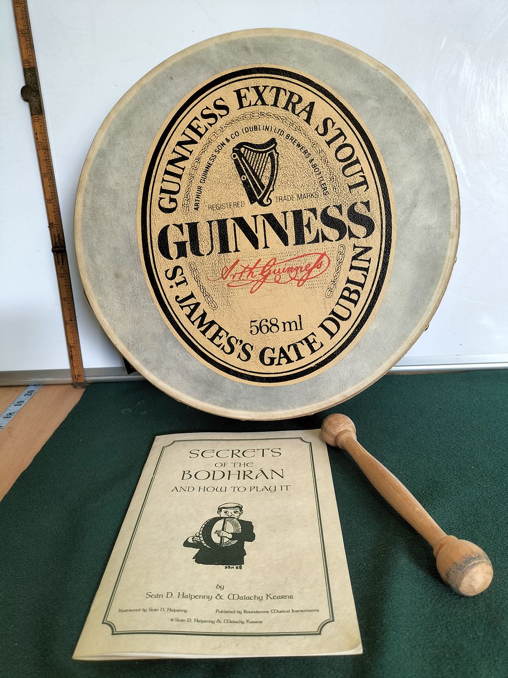 Lot 174 – A Guinness Branded Bodhrán, Tipper, and Instructional Booklet