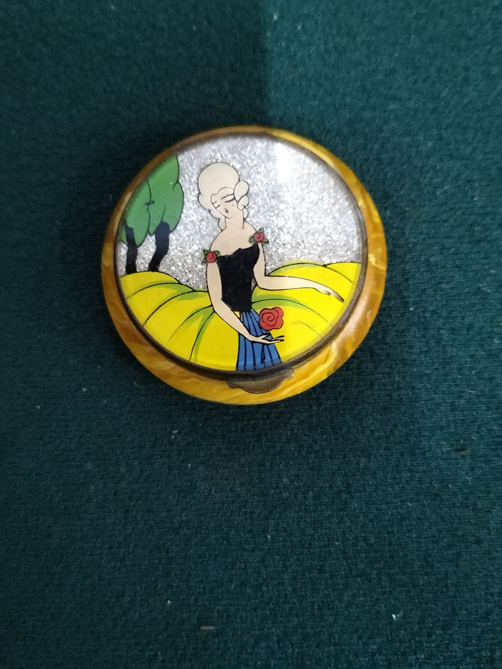 Lot 198 – Art Deco Marbled Yellow Celluloid Powder Compact with Crinoline Lady Motif
