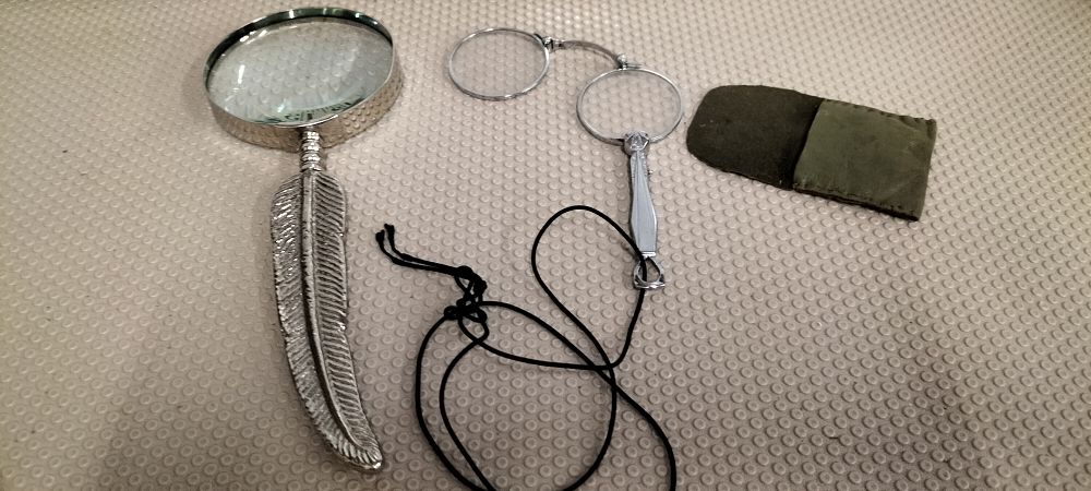 Lot 179 – Two Silver-Toned Decorative Optical Desk Accessories Comprising a Feather-Handle Magnifying Glass and a Folding Lorgnette