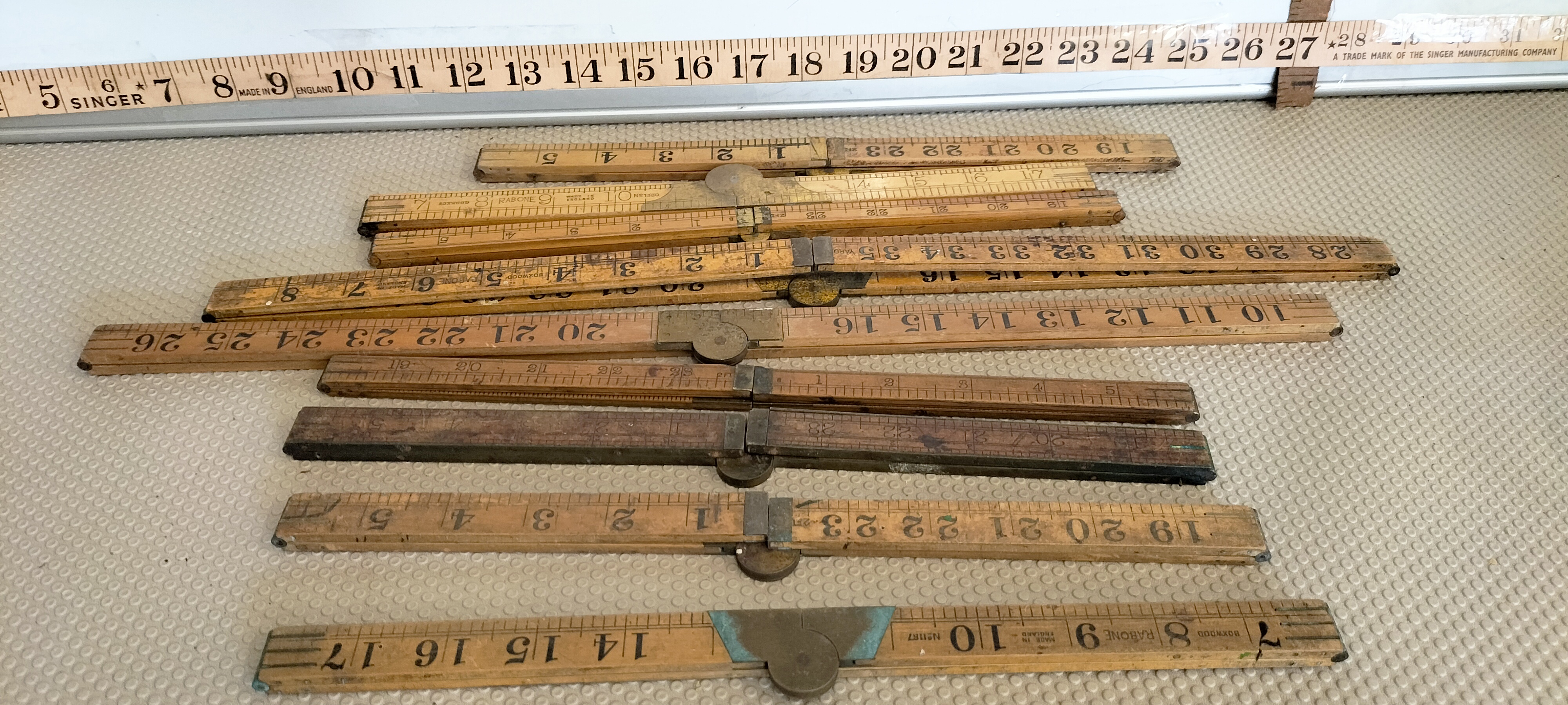 A Collection of Antique and Vintage Boxwood and Brass Measuring Rules including Rabone and Singer