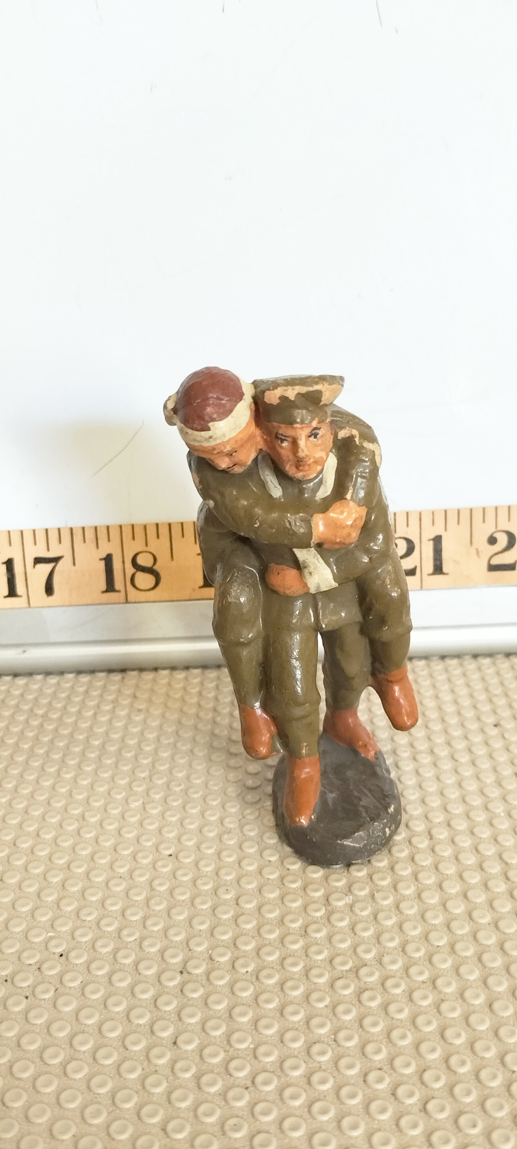 An Elastolin Composition Figure of a British Soldier Carrying a Wounded Comrade