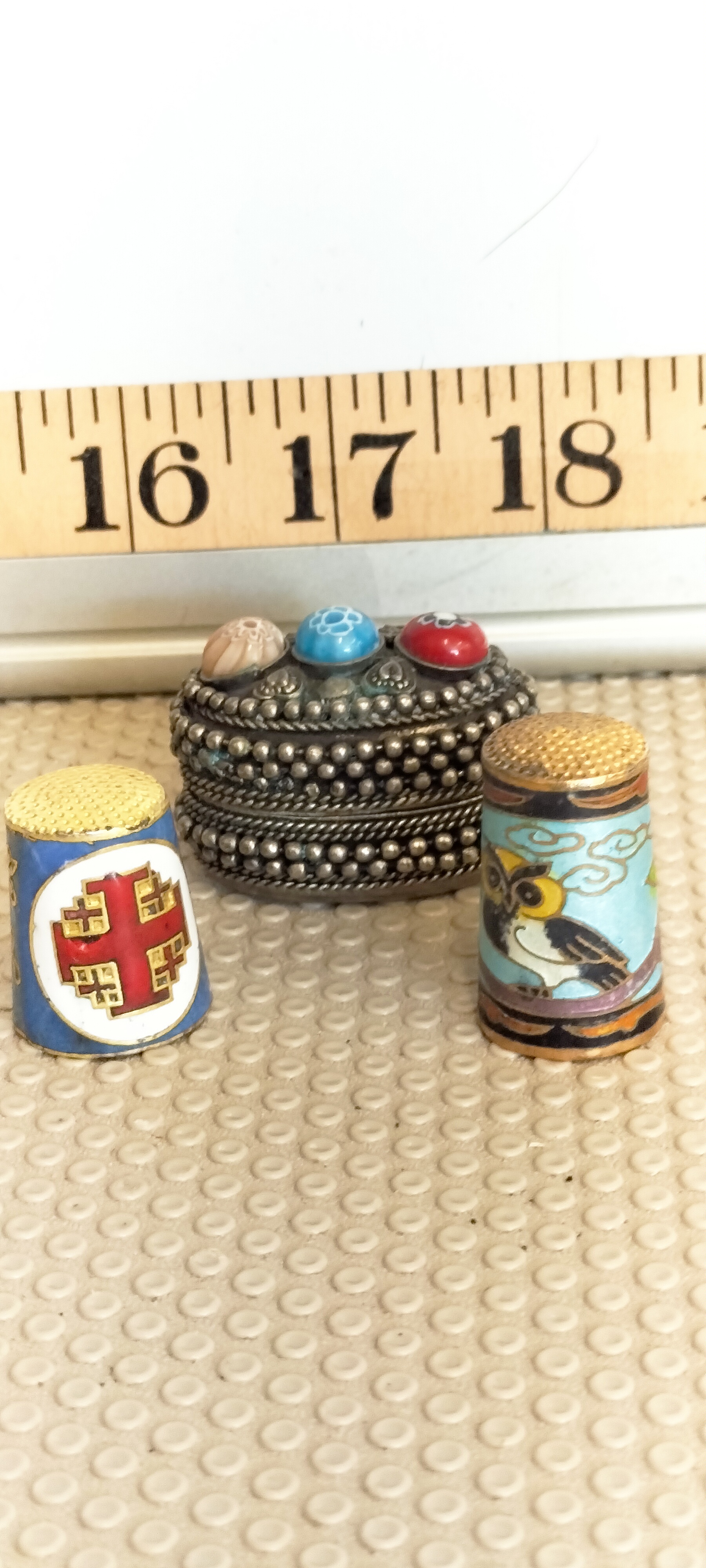 A Trio of Decorative Enamel Items Comprising Two Thimbles and a Filigree Trinket Box