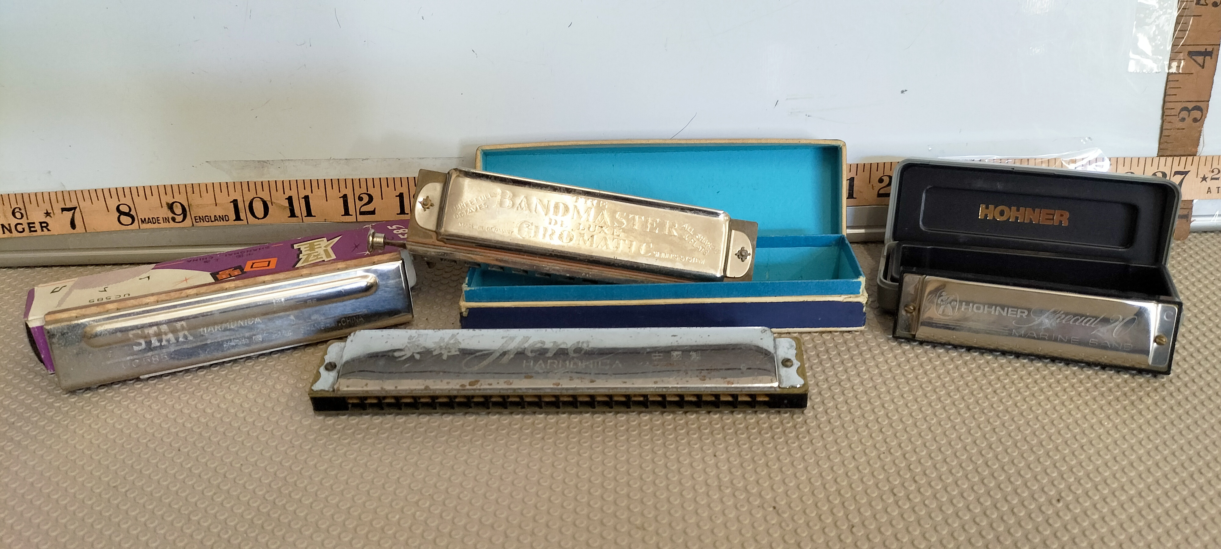 A Collection of Vintage Harmonicas Including Hohner, The Bandmaster, Hero, and Star Models