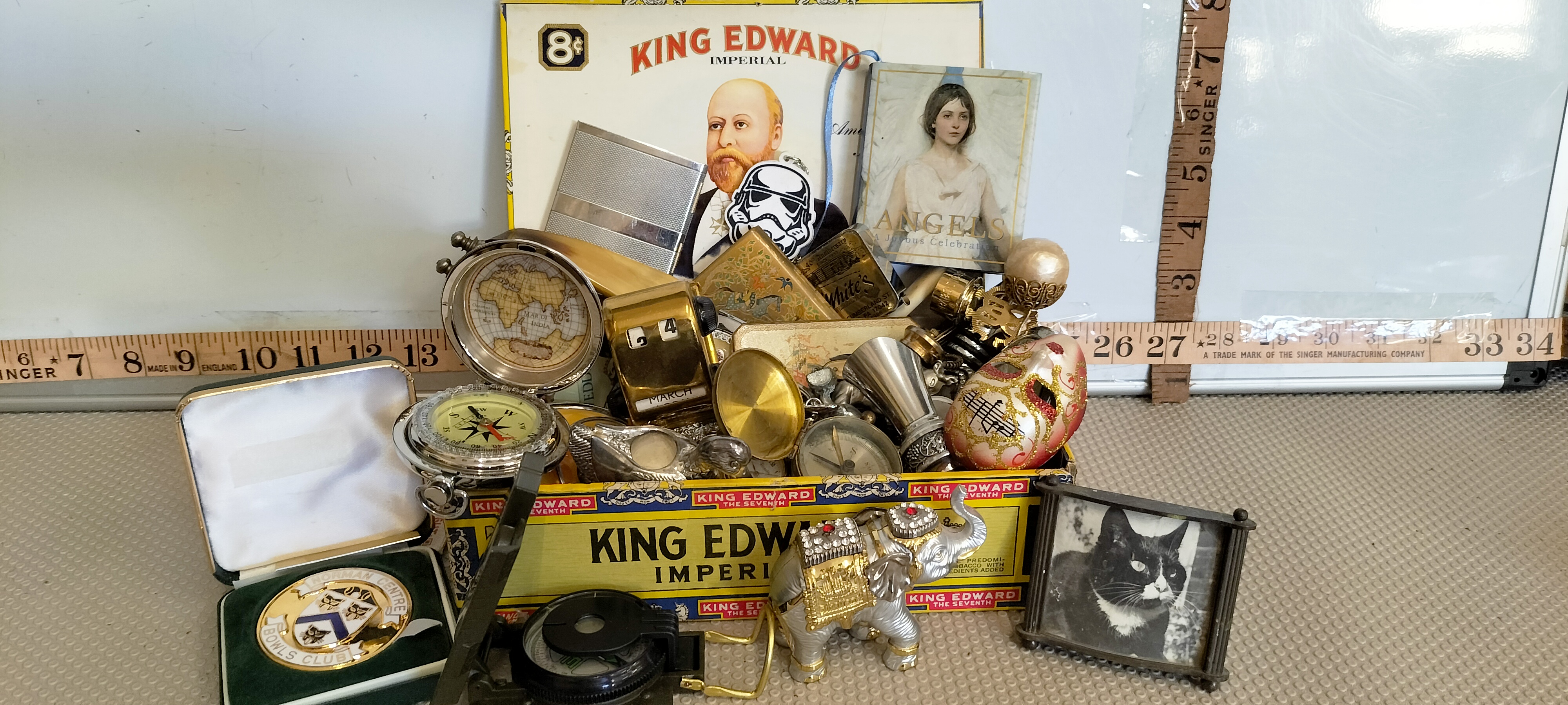 An Assortment of Vintage Collectibles and Curiosities Including a King Edward Imperial Cigar Box, Perpetual Calendar, and Compasses