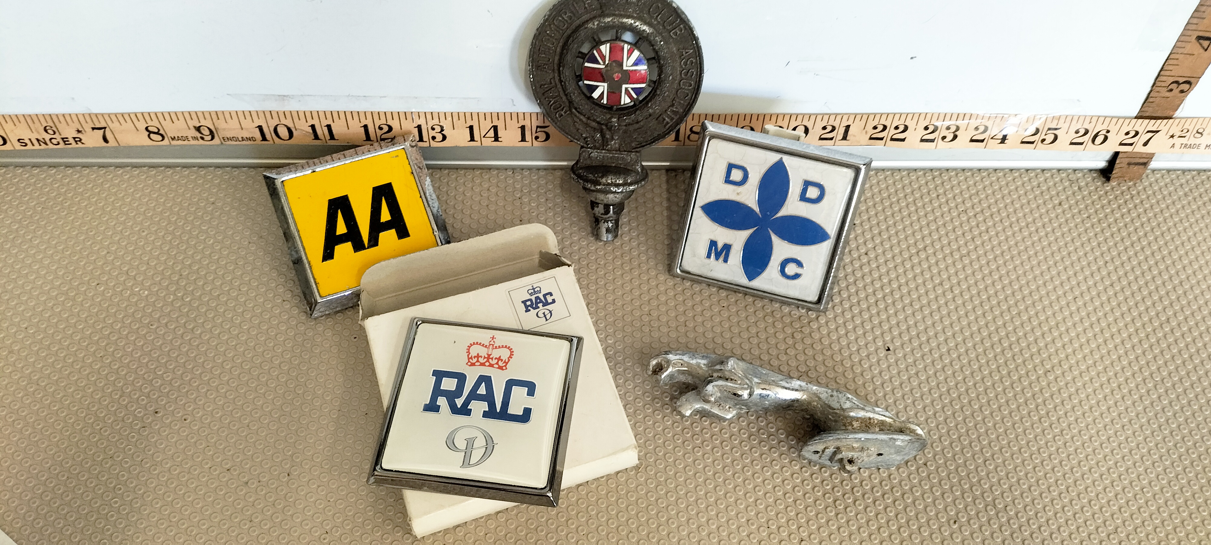 A Collection of British Automobile Club Grille Badges and a Jaguar Hood Mascot