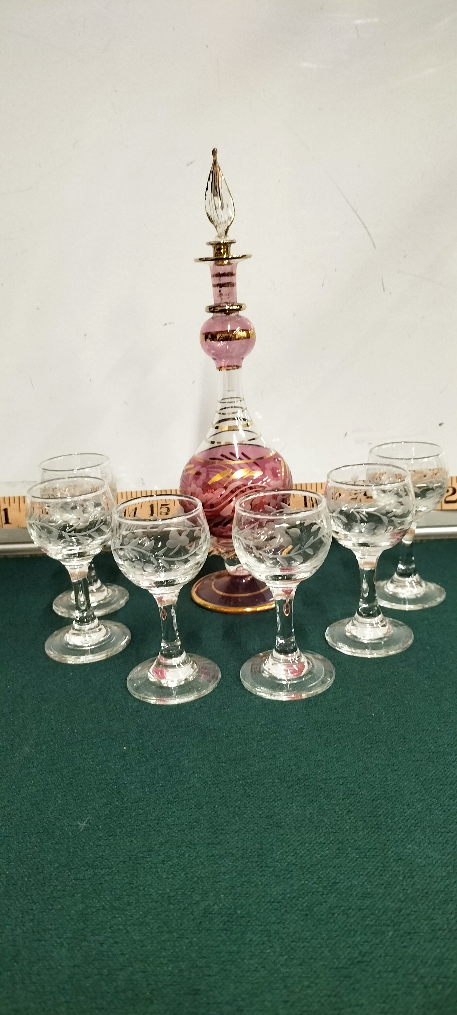A Bohemian Gilt and Etched Perfume Bottle and six Glass Liqueur Glasses
