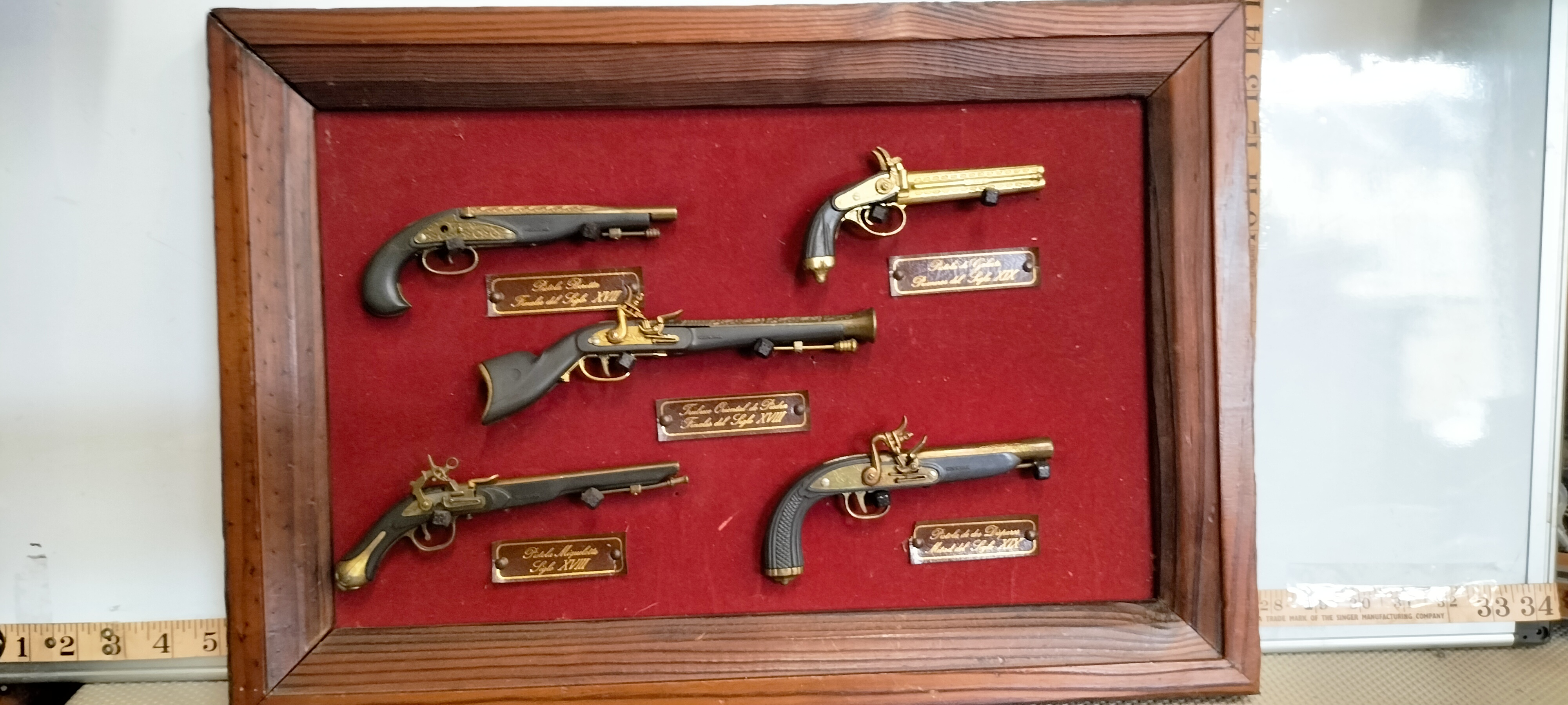A Collection of Decorative Miniature Replica Historical Firearms in a Shadow Box Display Case