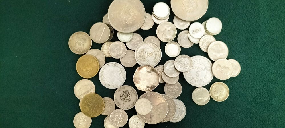 Lot 195 – A Collection of World Coins Including UK, FR, CH, MA, and US Issues