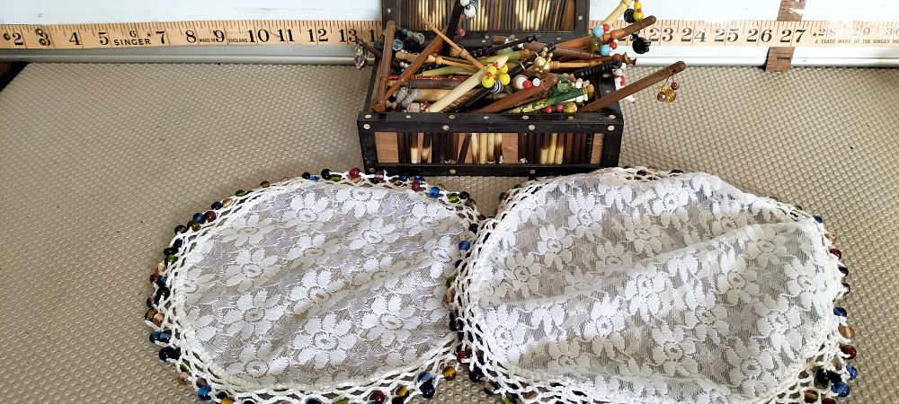 Lot 180 – A Collection of Antique and Vintage Lace Making Bobbins in a Porcupine Quill Box with Two Beaded Jug Covers