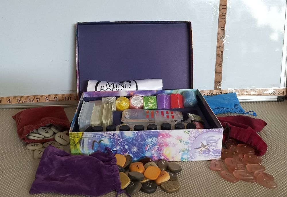 Lot 184 – A Mind Body Divination and Spiritualist Collection Including Runes, I Ching Cards, and Aromatherapy Accessories