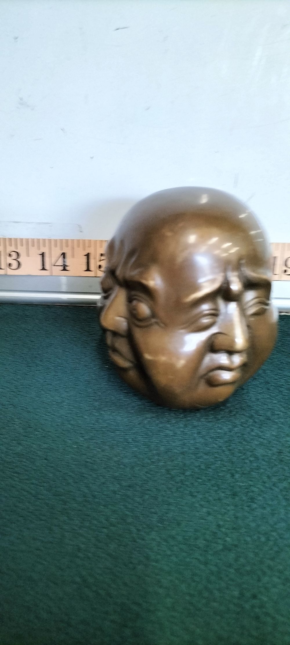 Lot 187 – A Bronze Four Faced Head Sculpture
