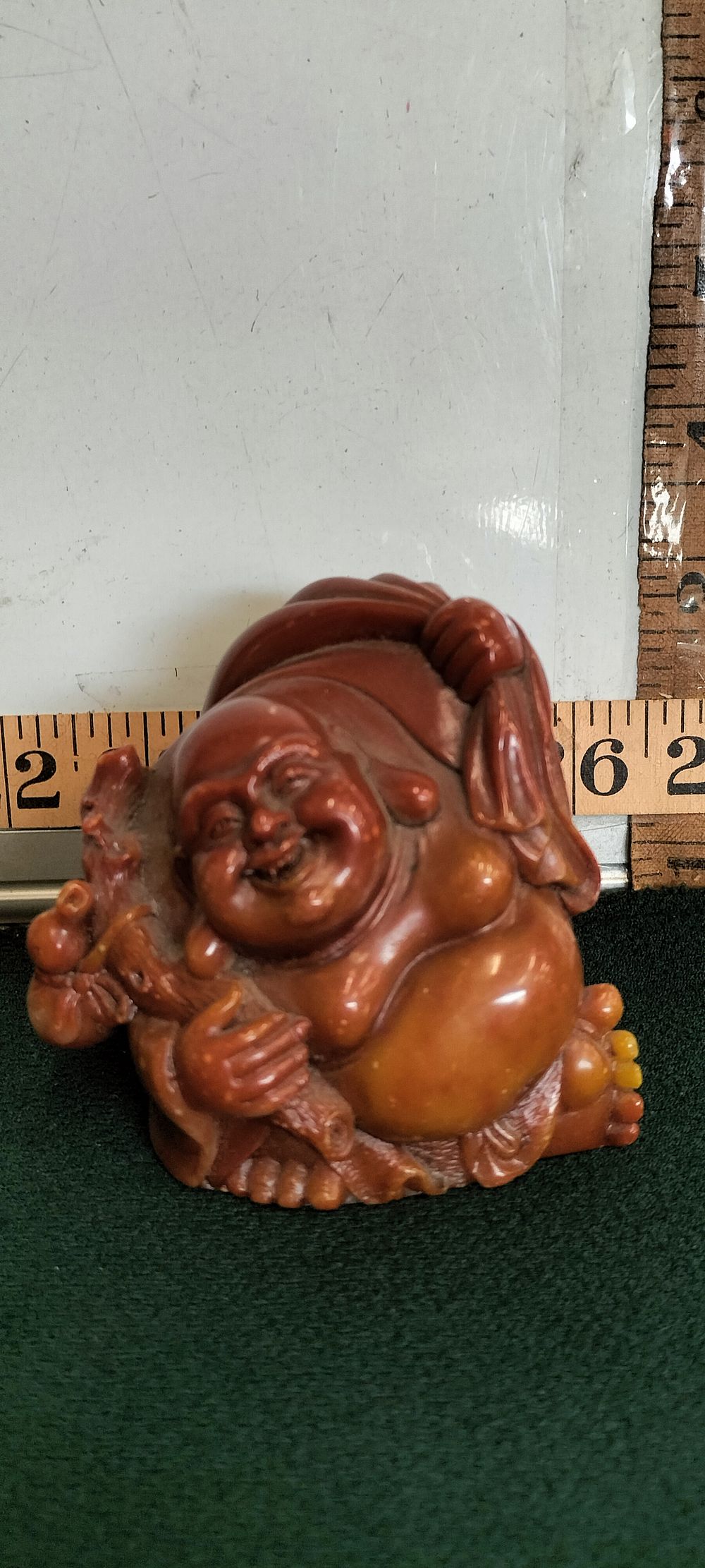 Lot 188 – A Carved Soapstone Budai Figurine with Staff and Sack