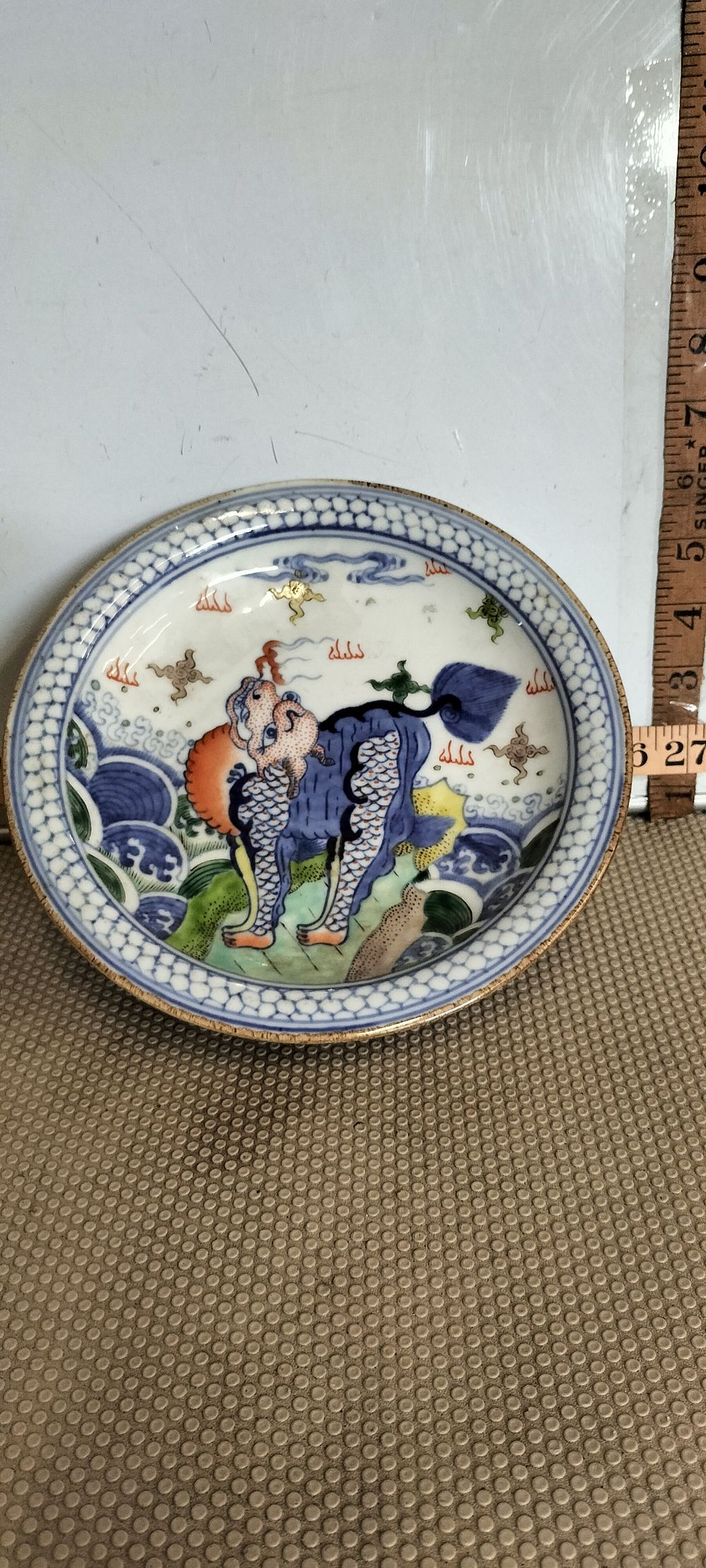 Lot 205 – A Porcelain Kangxi Period Wucai Mythological Creature Motif Dish