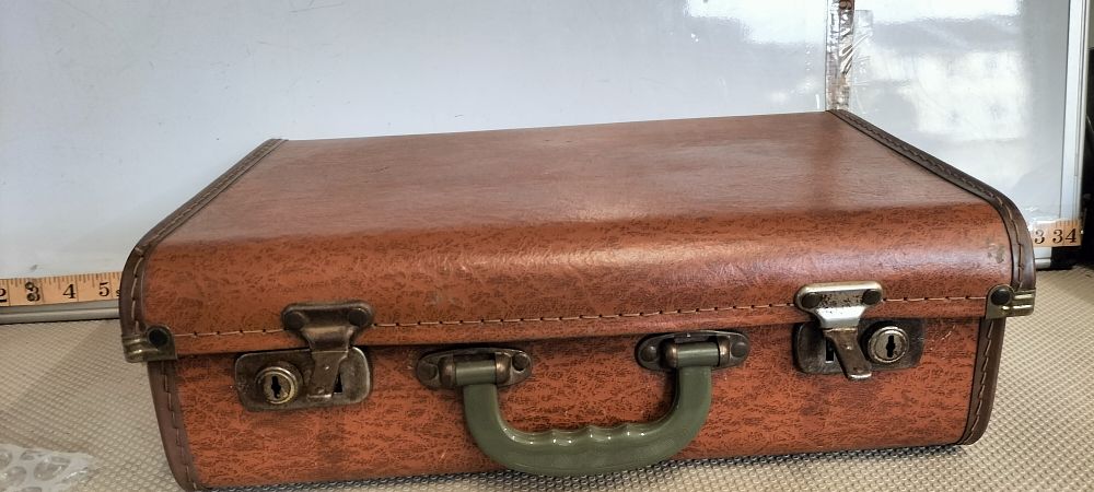 Lot 234 – A Vinyl Mid-Century Case with Grid Pattern Lining