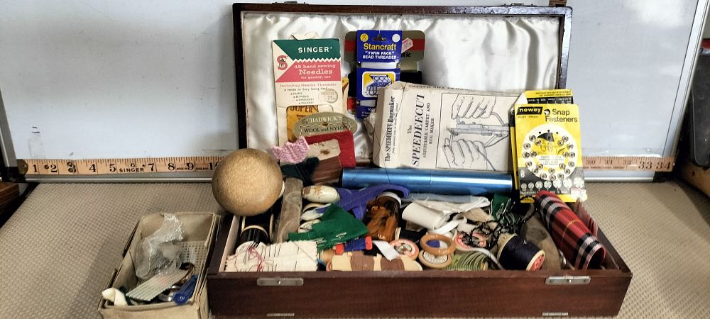 Lot 260 – A Wood Sewing Box containing Singer and Speedeecut Haberdashery
