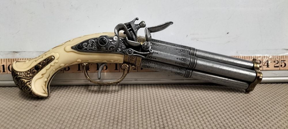 Lot 184 – A Synthetic Ivory and Metal Four Barrel Flintlock Turnover Pistol