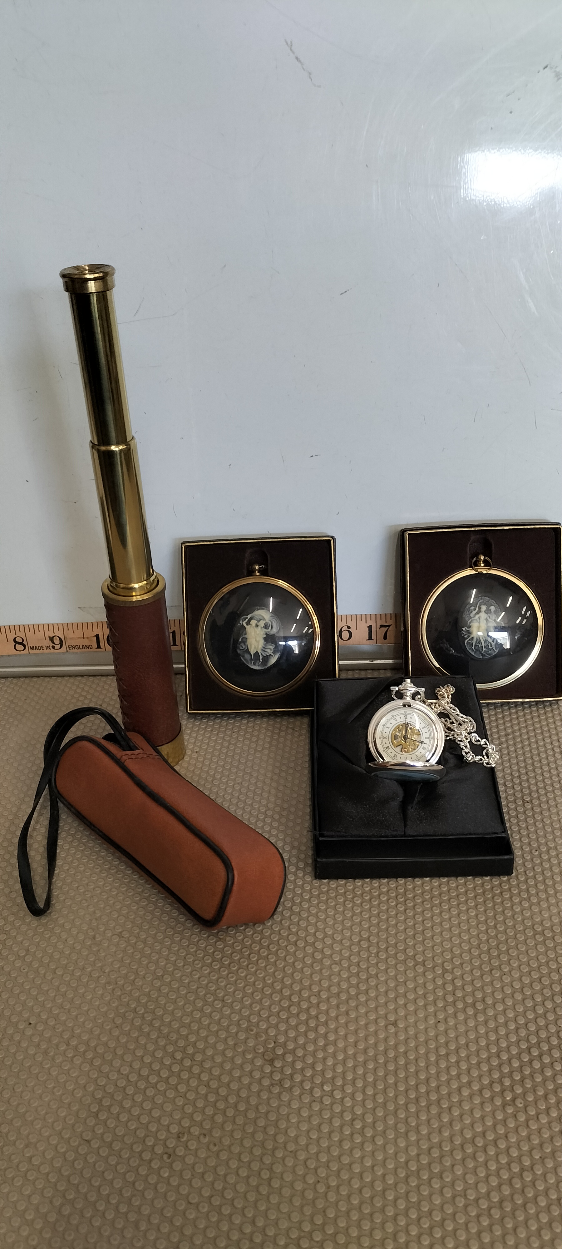 A Silver Skeleton Pocket Watch With Brass Telescope and Medallions