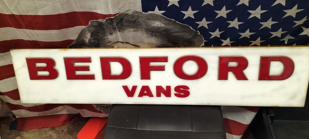 Lot 81 – A Plastic and Wood Bedford Vans Advertising Sign