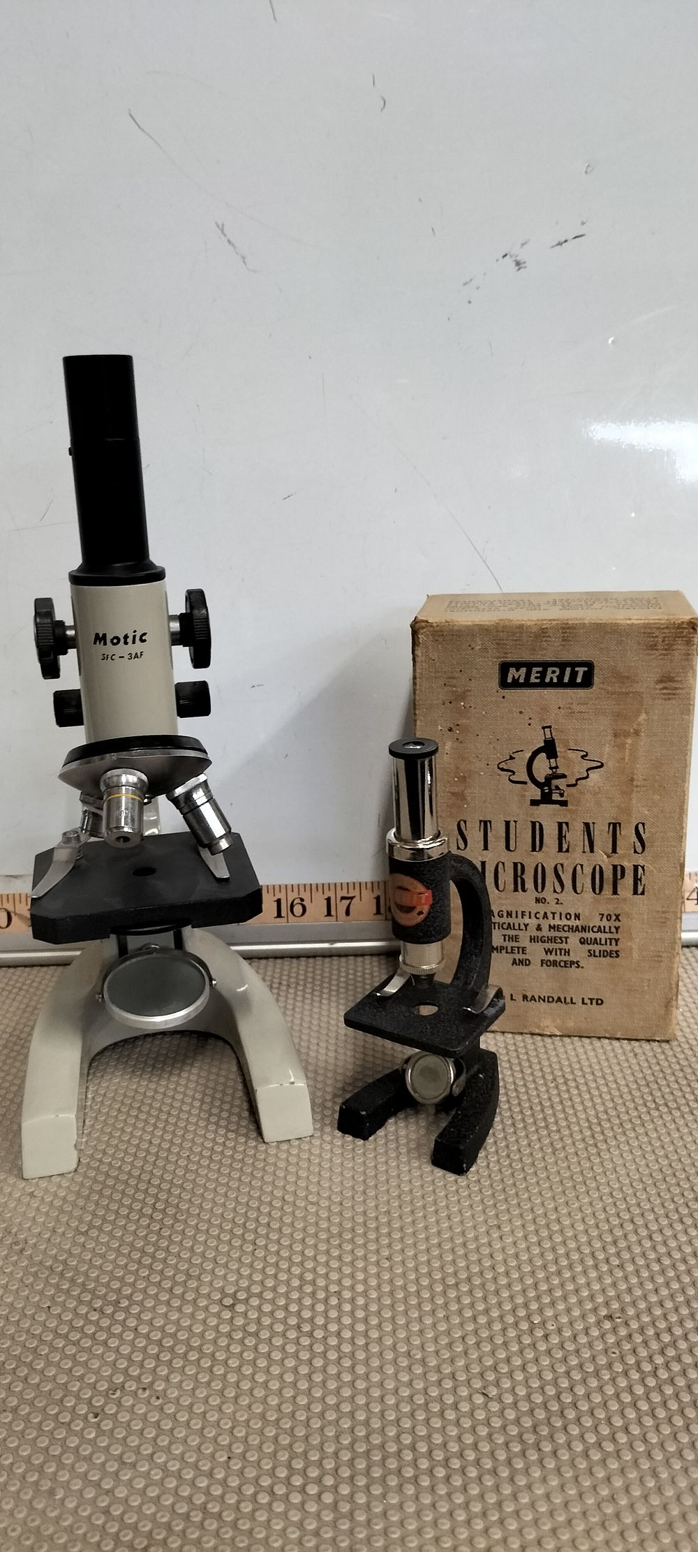Lot 92 – Two Motic and Merit Monocular Compound Microscopes