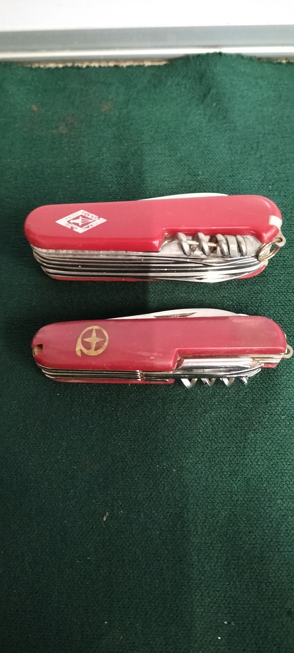 Lot 116 – Two Red Multi Tool Pocket Knives