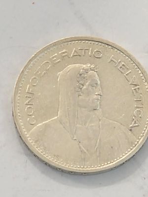 מטבע כסף בערך חמש פרנק שוויץ 
שנת הנפקה 1953 
קוטר 31.45 מ"מ משקל 15 גרם
