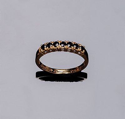 Anillo media alianza en oro amarillo 18 K, con frente en fila de zafiritos azules en garras. Nº 