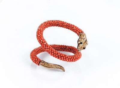 Bonito brazalete antiguo en forma de drag&oacute;n, realizado con cuentas de coral trenzadas, y cabeza 
