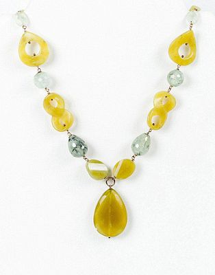 Collar de grandes cuentas, algunas con formas caladas, de &aacute;gata amarilla, con perilla central 