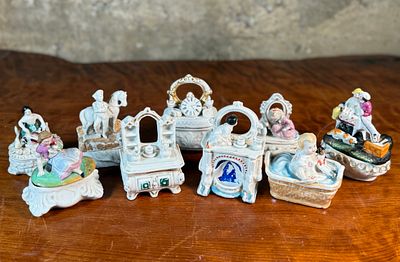 PORCELAIN "FAIRING" TRINKET BOXES. This lot features a collection of antique porcelain "fairing" 