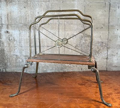 ART NOUVEAU BRASS MAGAZINE RACK. This lot features an Art Nouveau brass and wood magazine rack 
