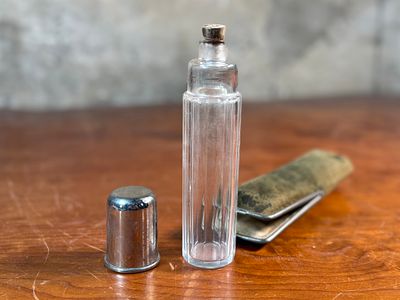 VICTORIAN ERA BOTTLE & CASE. This lot features a Victorian era bottle with a cork top and silver 