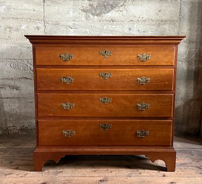 CHERRY WOOD CHIPPENDALE-STYLE CHEST OF DRAWERS. This lot features a solid cherry wood 