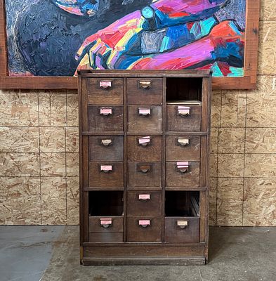 ANTIQUE WOOD APOTHECARY CABINET. This lot features an antique wood apothecary or library card 