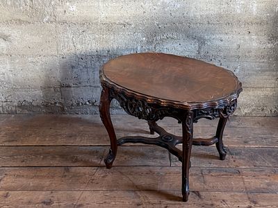 ROCOCO-STYLE CARVED OVAL CENTER TABLE. This lot features an antique Victorian or Rococo-style 