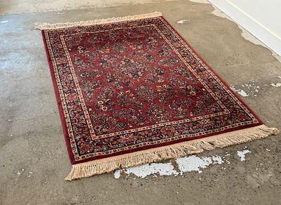 RED SAROUK KARASTAN RUG #2. This lot features a stunning red Sarouk Karastan rug that measures 