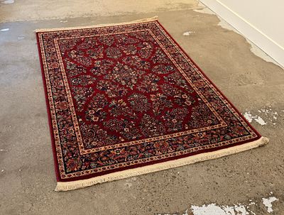 RED SAROUK KARASTAN RUG #1. This lot features a stunning red Sarouk Karastan rug that measures 
