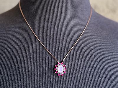 SILVER QUARTZ & RUBY PENDANT NECKLACE. This lot features a stunning rose gold colored silver 