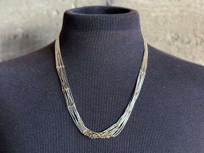 LIQUID SILVER & 14K GOLD NECKLACE. This lot features a stunning liquid silver and 14k gold 
