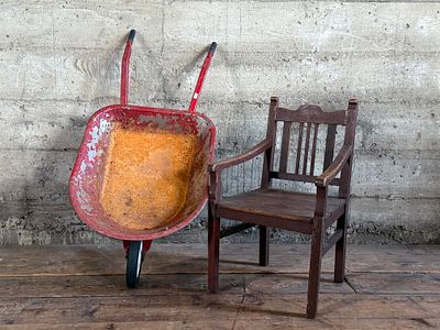 CHILDREN'S CHAIR & WHEELBARROW . This lot features an antique children's chair and child's size 