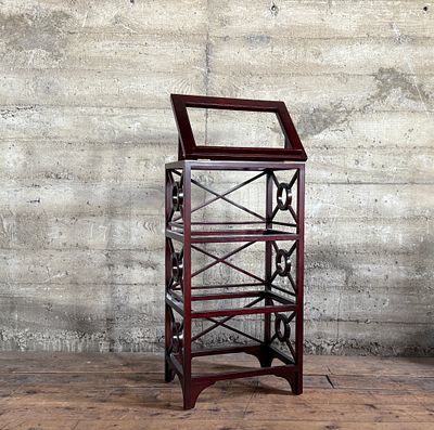 LIBRARY BOOK STAND. This lot features a library book stand, made of teak with a mahogany finish. 