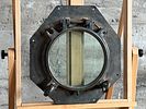 NAUTICAL PORTHOLE WINDOW. This lot features an authentic salvaged nautical porthole window that Image - 1