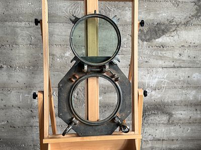 NAUTICAL PORTHOLE WINDOW. This lot features an authentic salvaged nautical porthole window that 