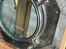 NAUTICAL PORTHOLE WINDOW. This lot features an authentic salvaged nautical porthole window that Image - 6