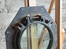 NAUTICAL PORTHOLE WINDOW. This lot features an authentic salvaged nautical porthole window that Image - 2