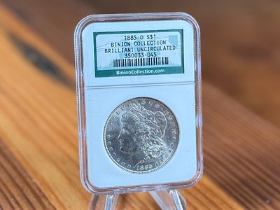 1885-O MORGAN DOLLAR. This lot features a brilliant uncirculated 1885-O Morgan Dollar in a 